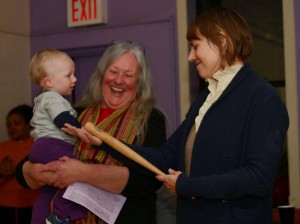 Joanne Sheehan (with grandson Seamus) receiving the Ralph DiGia award from WRL Organizing Coordinator Kimber Heinz